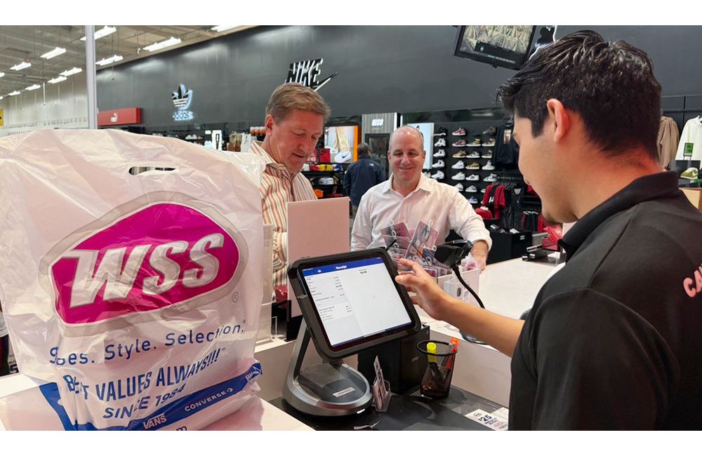 Several Aptos executives, including Carl Nemec (L) and Jeremy Grunzweig (R), recently visited a WSS store in California following its rollout of Aptos ONE POS.